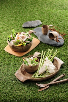 Elegant bagasse bowls filled with fresh salad on a rustic table.