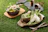 A rustic table setting featuring colorful stoneware plates stacked with fresh fruit and flowers.