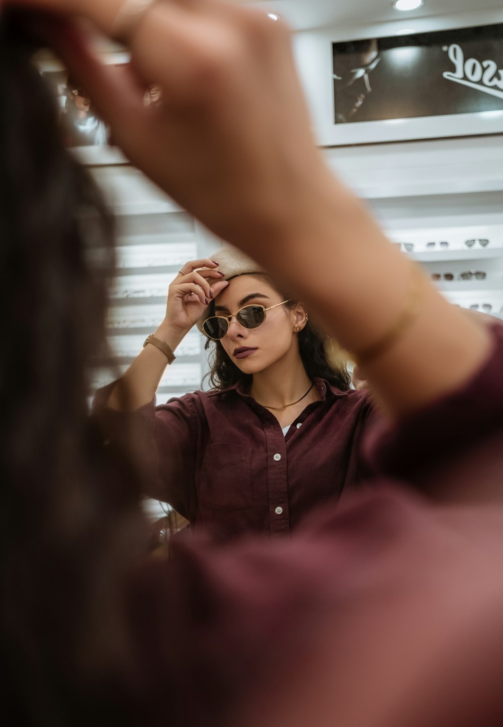 a woman is looking at her reflection in the mirror