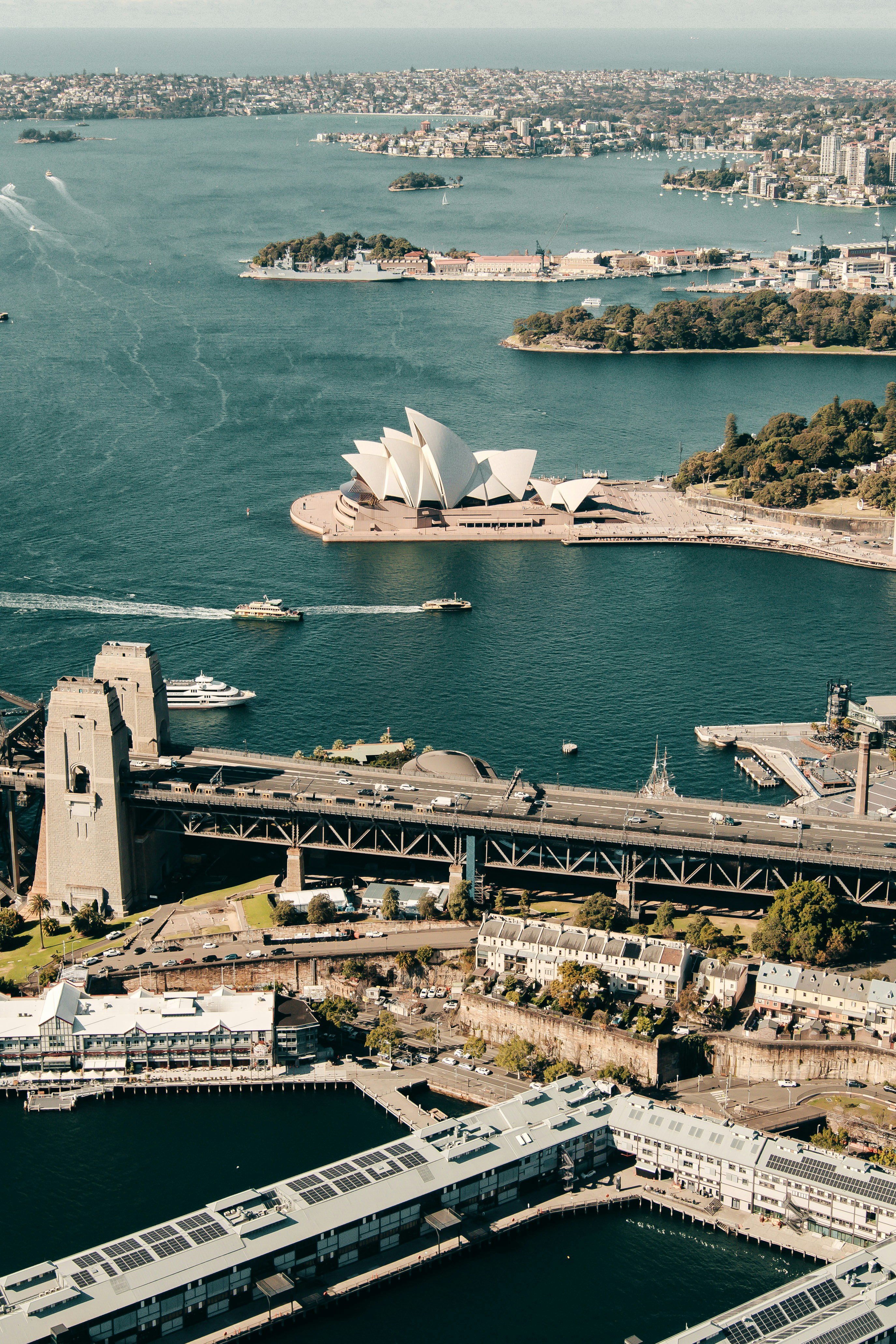 Sydney Harbour Bridge and Opera House from aerial view, blue sky sunny day