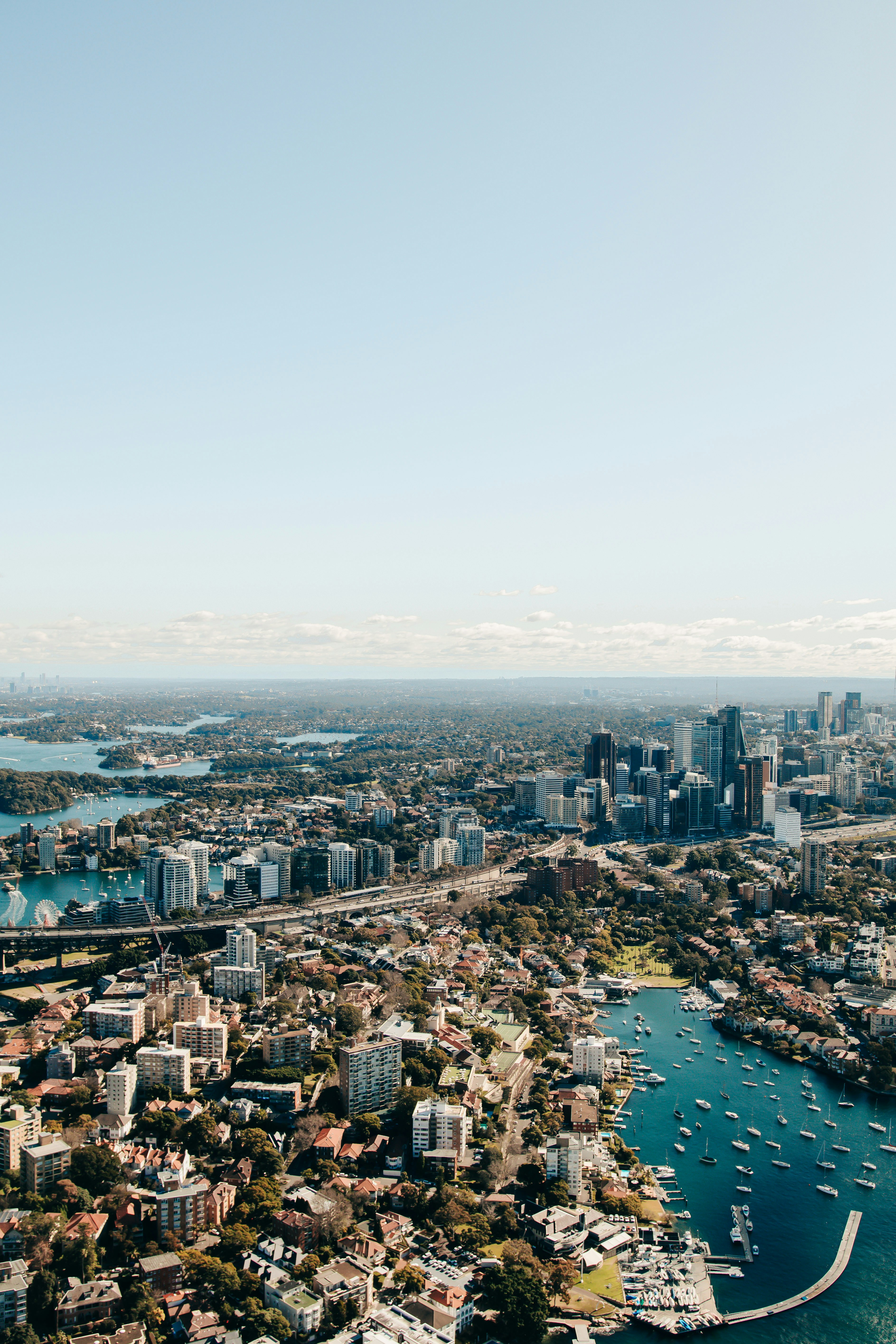 an aerial view of a city with boats in the water