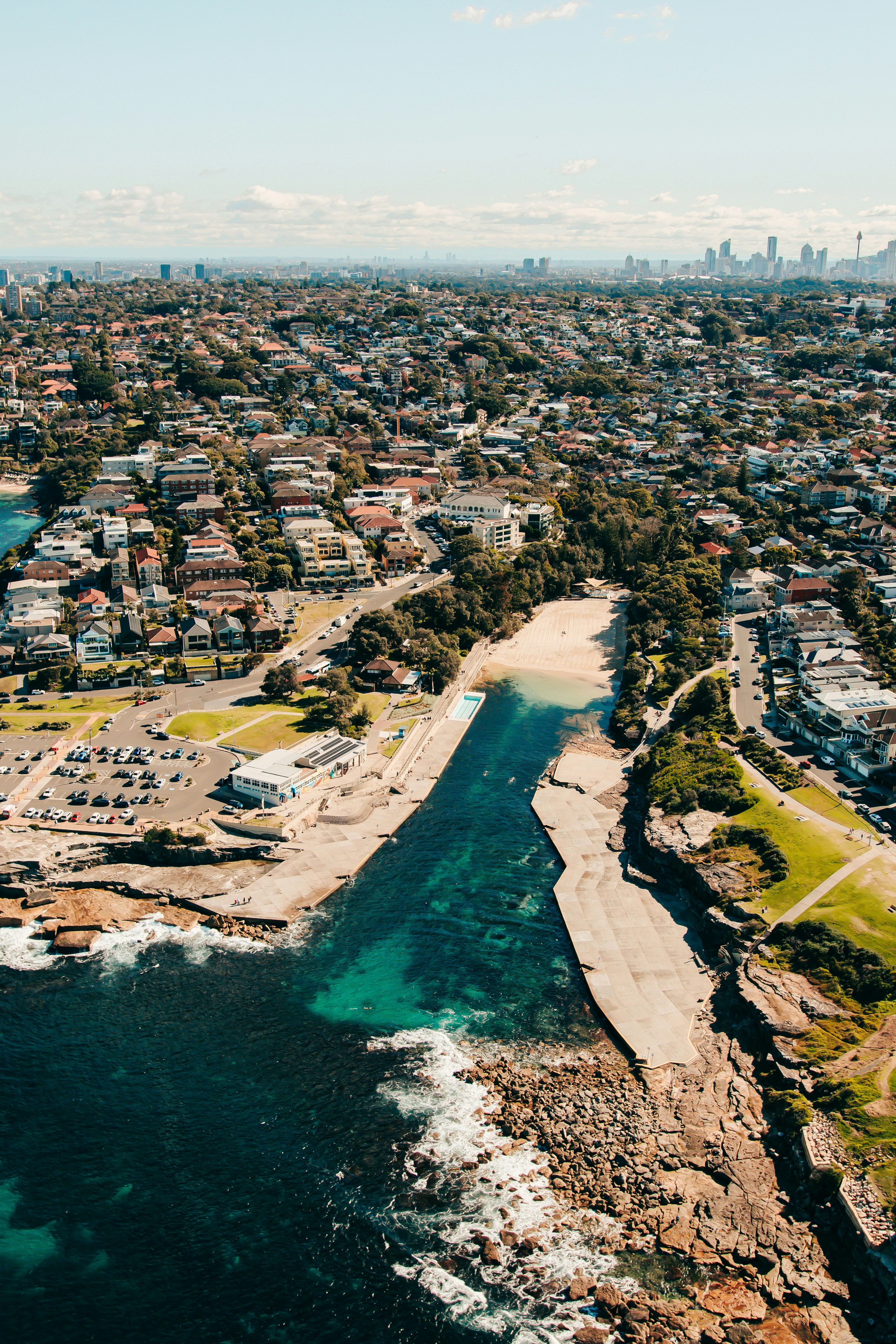 an aerial view of a city and a body of water
