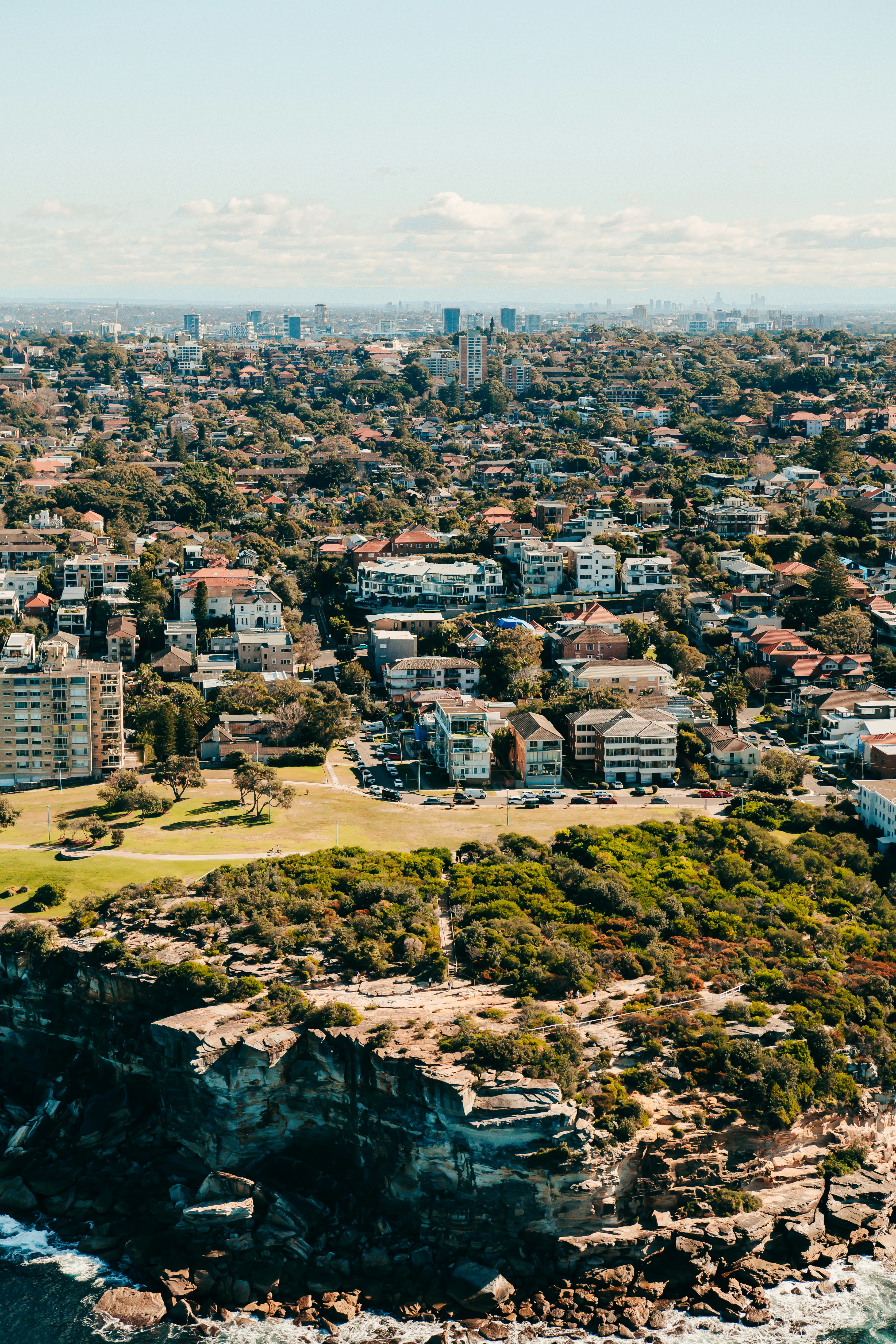 an aerial view of a city and the ocean