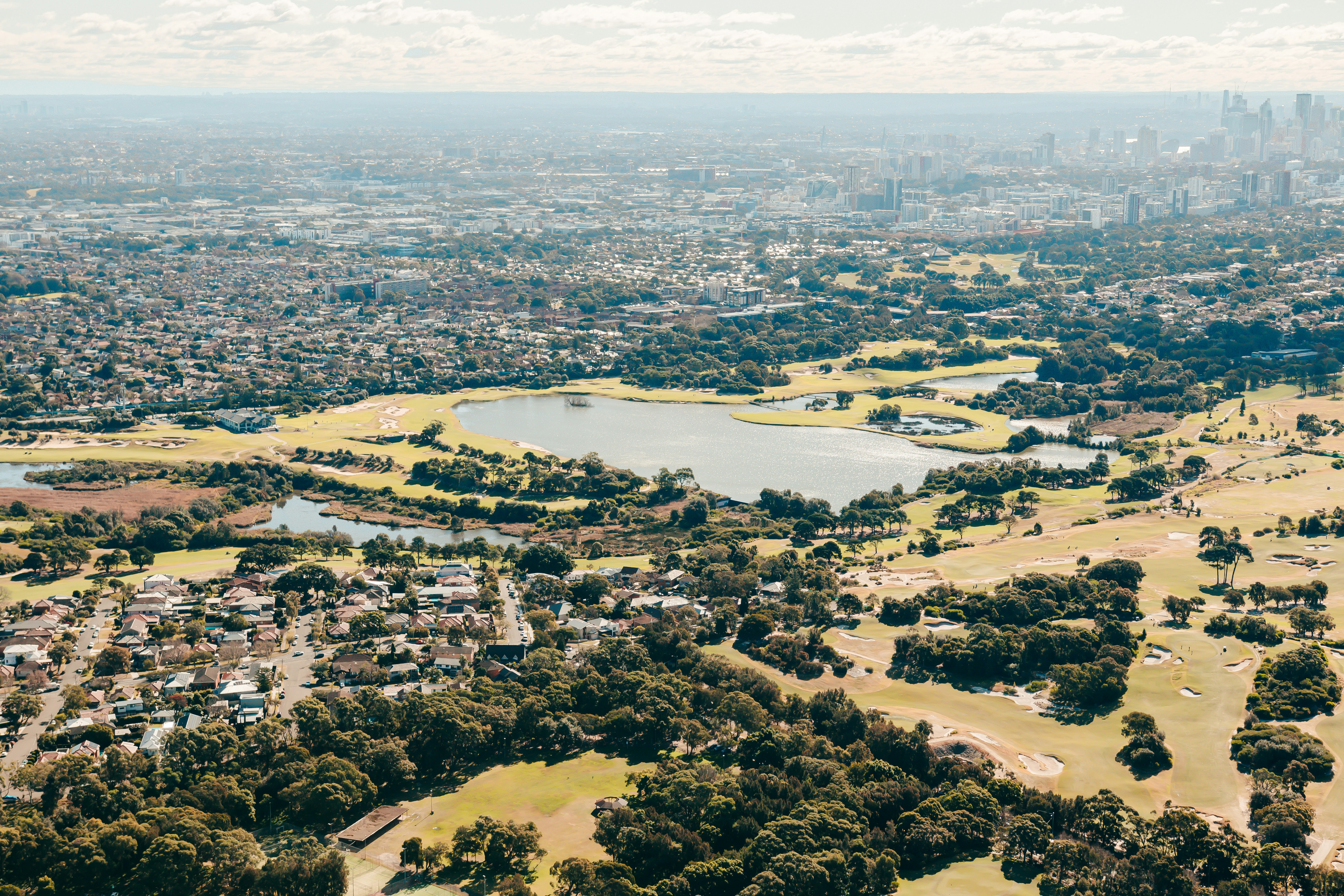 an aerial view of a city and a lake
