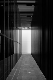 a black and white photo of a long hallway