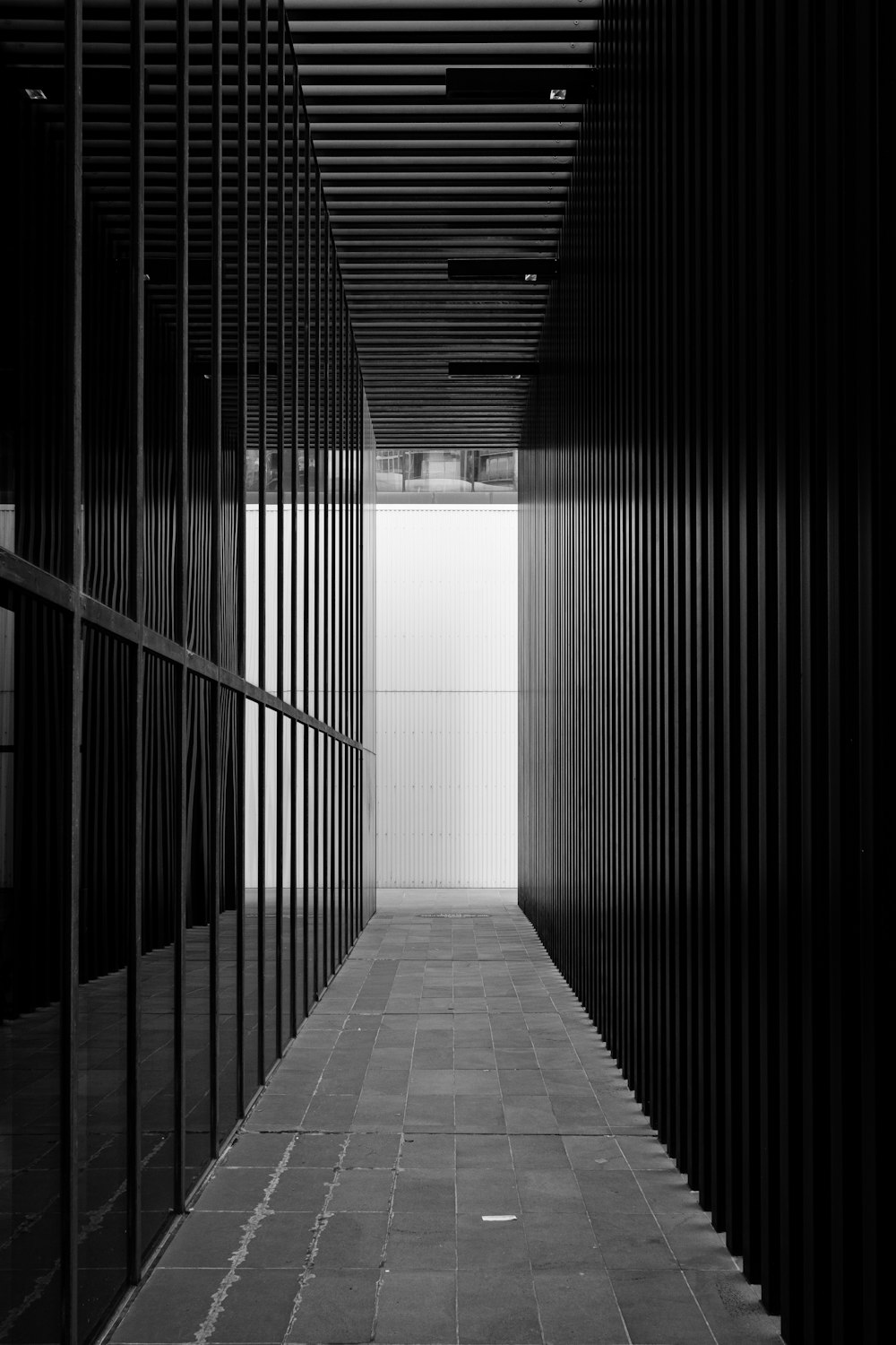 a black and white photo of a long hallway