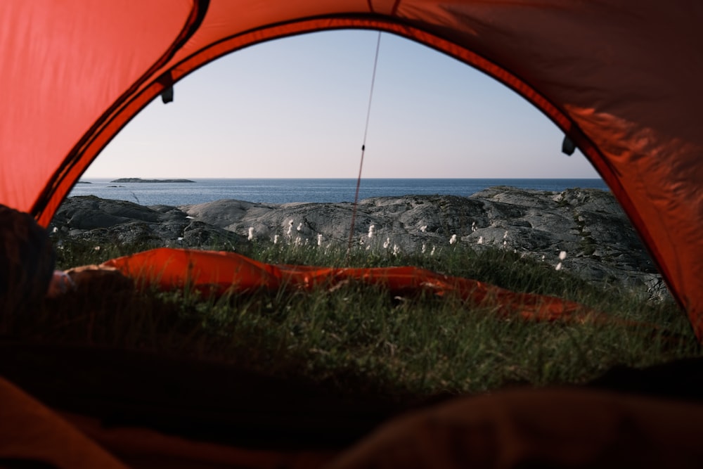 a view of the ocean from inside a tent