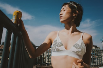 A sunlit morning scene with a woman enjoying a peaceful moment with her wellness supplements on a cozy balcony.