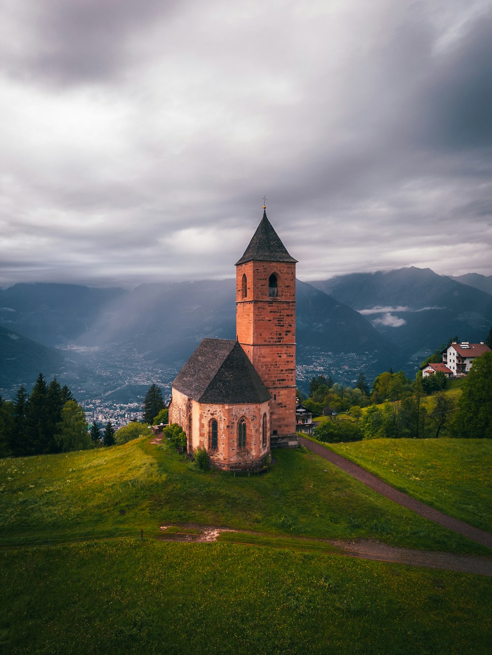 a church on a hill with a view of a valley