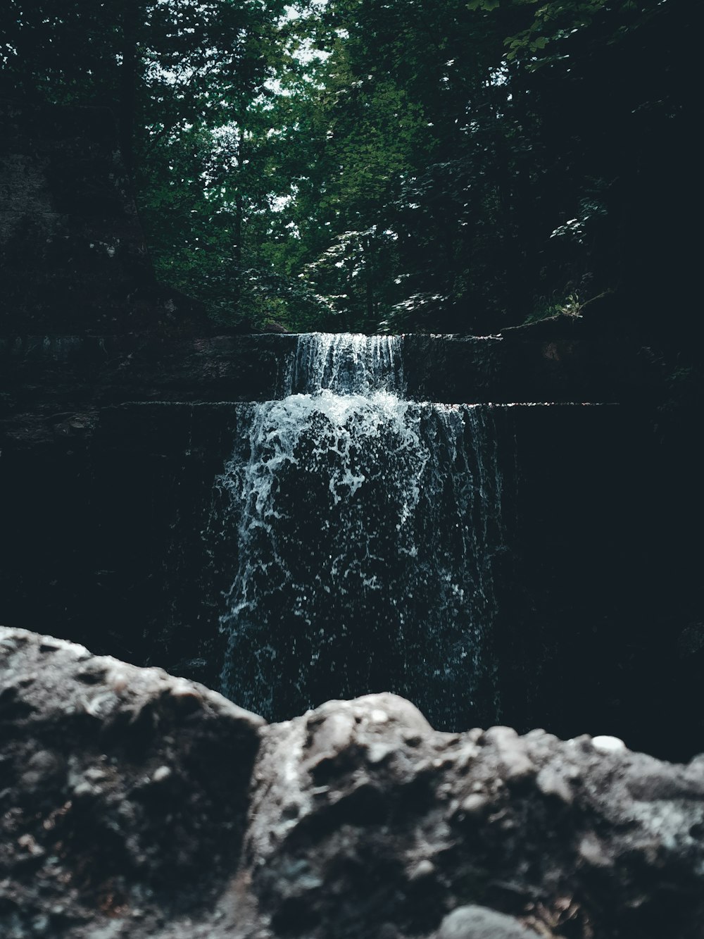 a waterfall in the middle of a forest