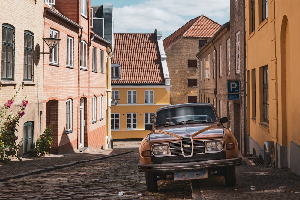 a car parked on a cobblestone street in a city