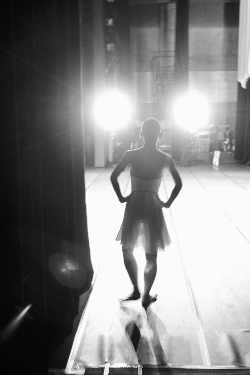 a woman standing on a stage in front of a light