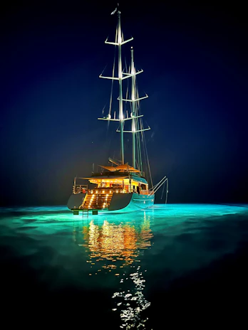 A cozy evening on deck with warm lights glowing, the tropical teal sails gently swaying in the breeze.