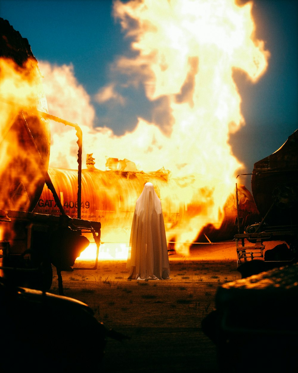 a ghost standing in front of a large fire