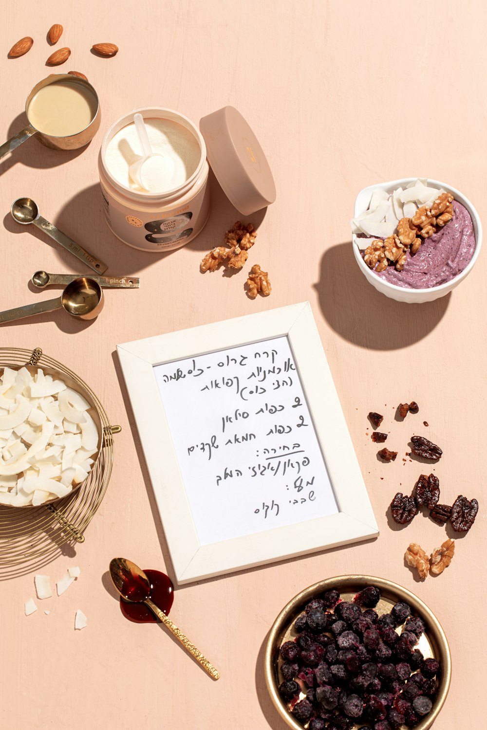 a table topped with bowls of food and a note