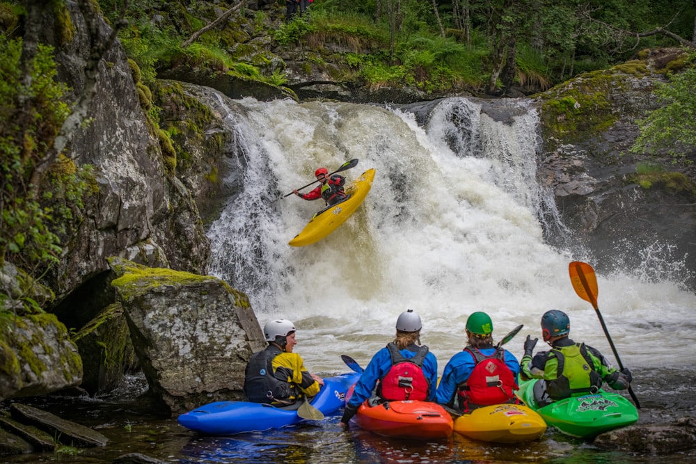 a group of people riding kayaks on top of a river