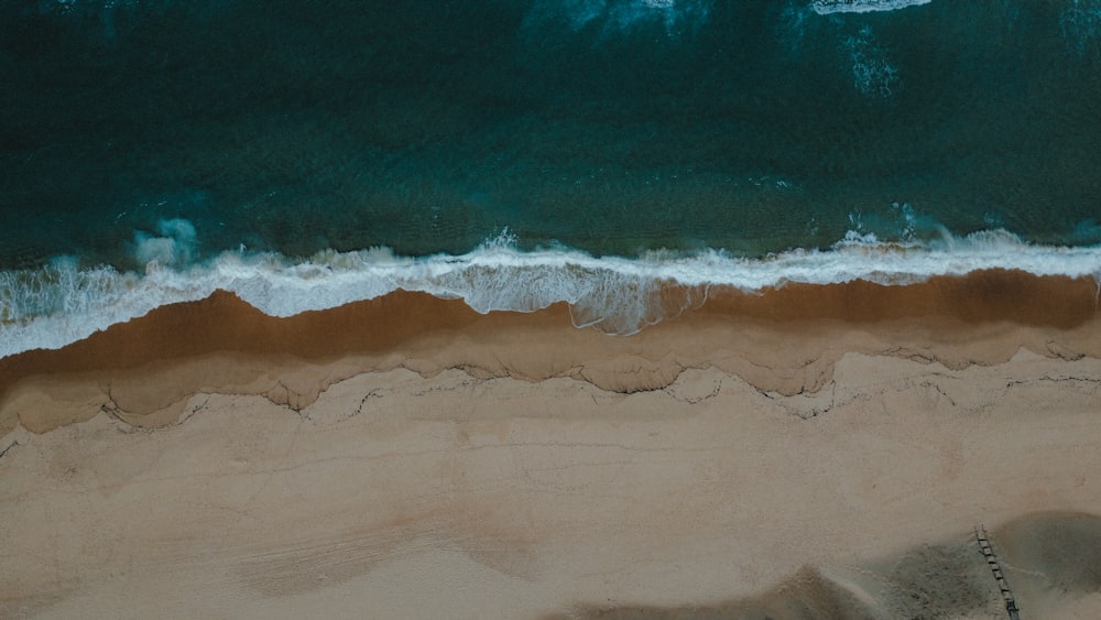 an aerial view of a sandy beach and ocean