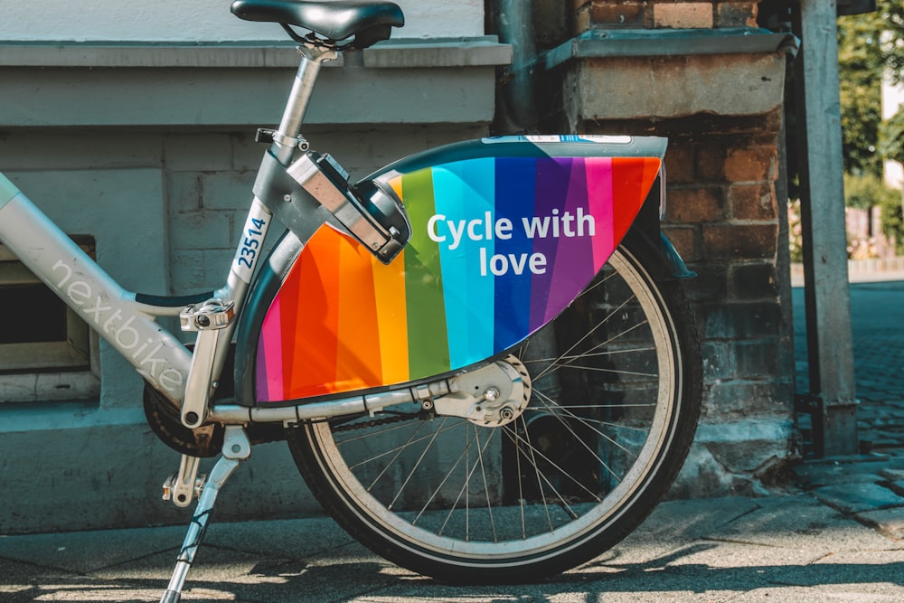 a bicycle with a colorful sign on the front of it