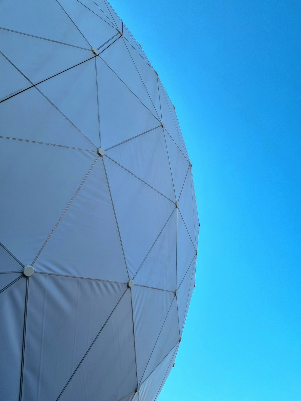 a large white object with a blue sky in the background