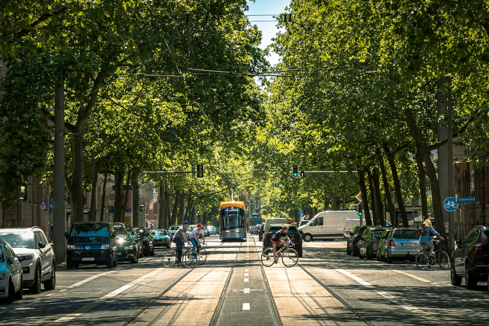 a group of people riding bikes down a street