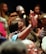 A close-up of a woman confidently leading a workshop, engaging with her audience.