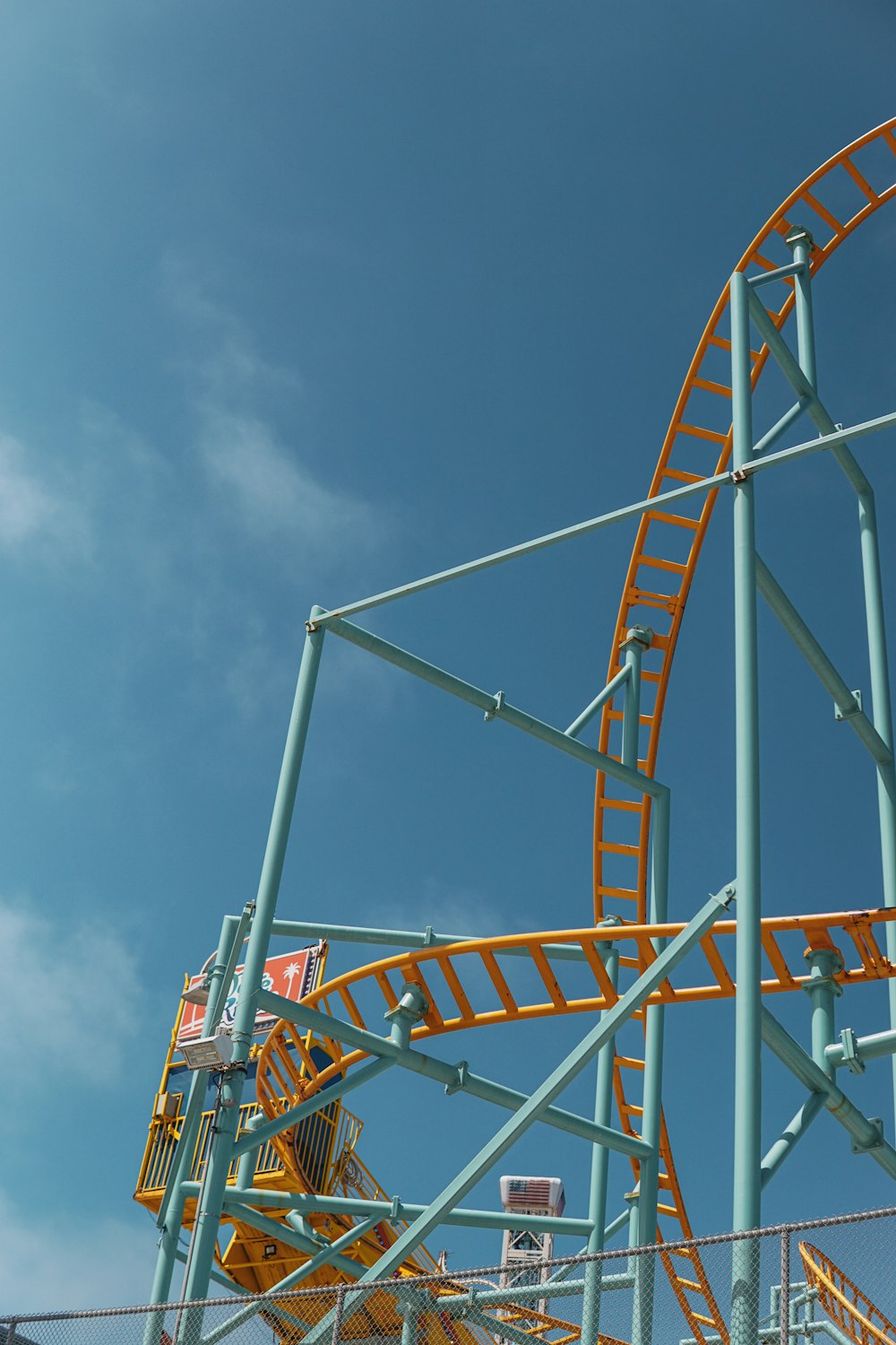 a roller coaster with a blue sky in the background