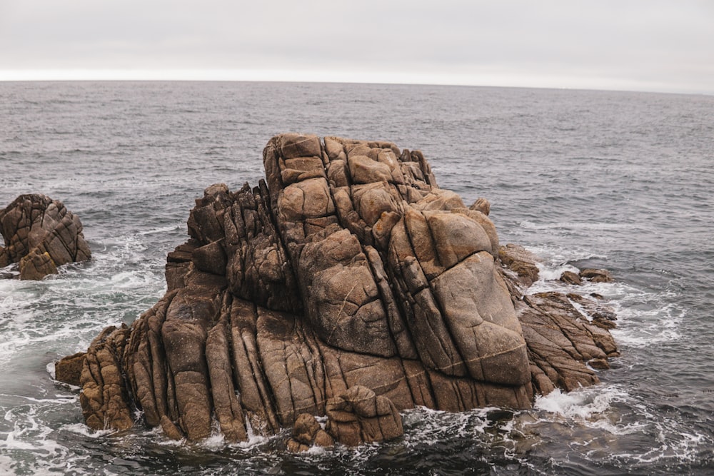 a rock outcropping in the middle of the ocean