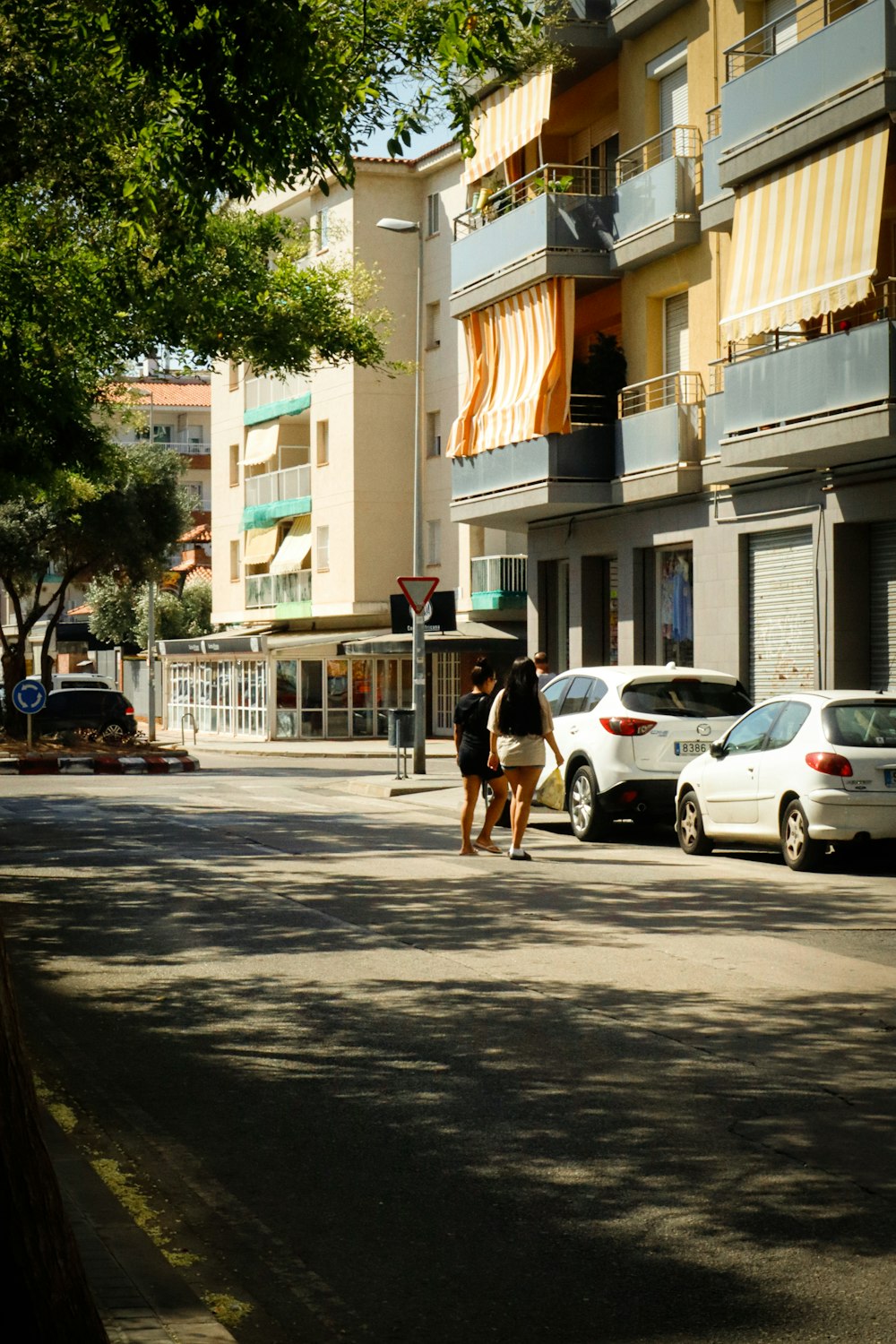 a couple of people walking down a street