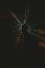 a black and white photo of a person in the dark