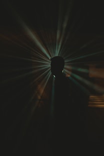 a black and white photo of a person in the dark