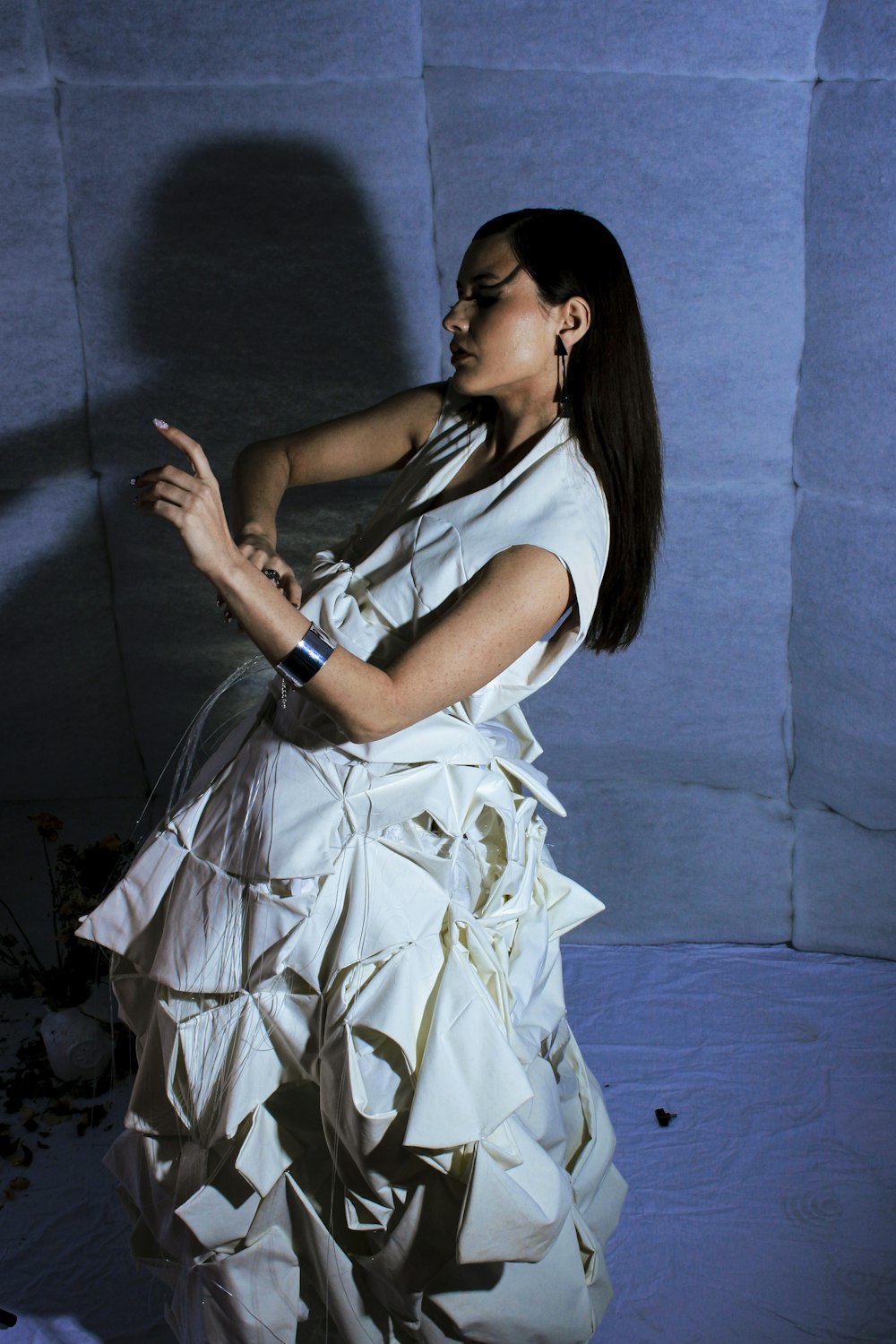 a woman in a white dress holding a cell phone