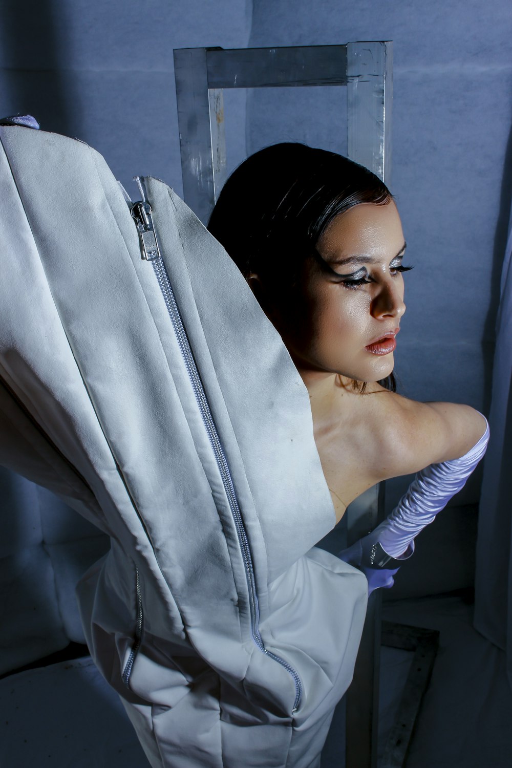 a woman in a white dress is holding a white bag