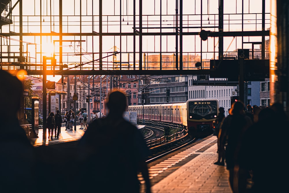 a train traveling down train tracks next to a train station