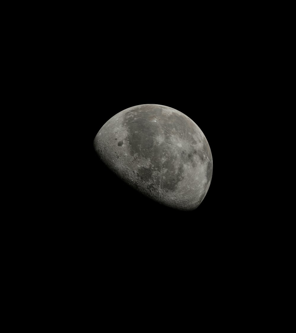 a half moon is seen in the dark sky