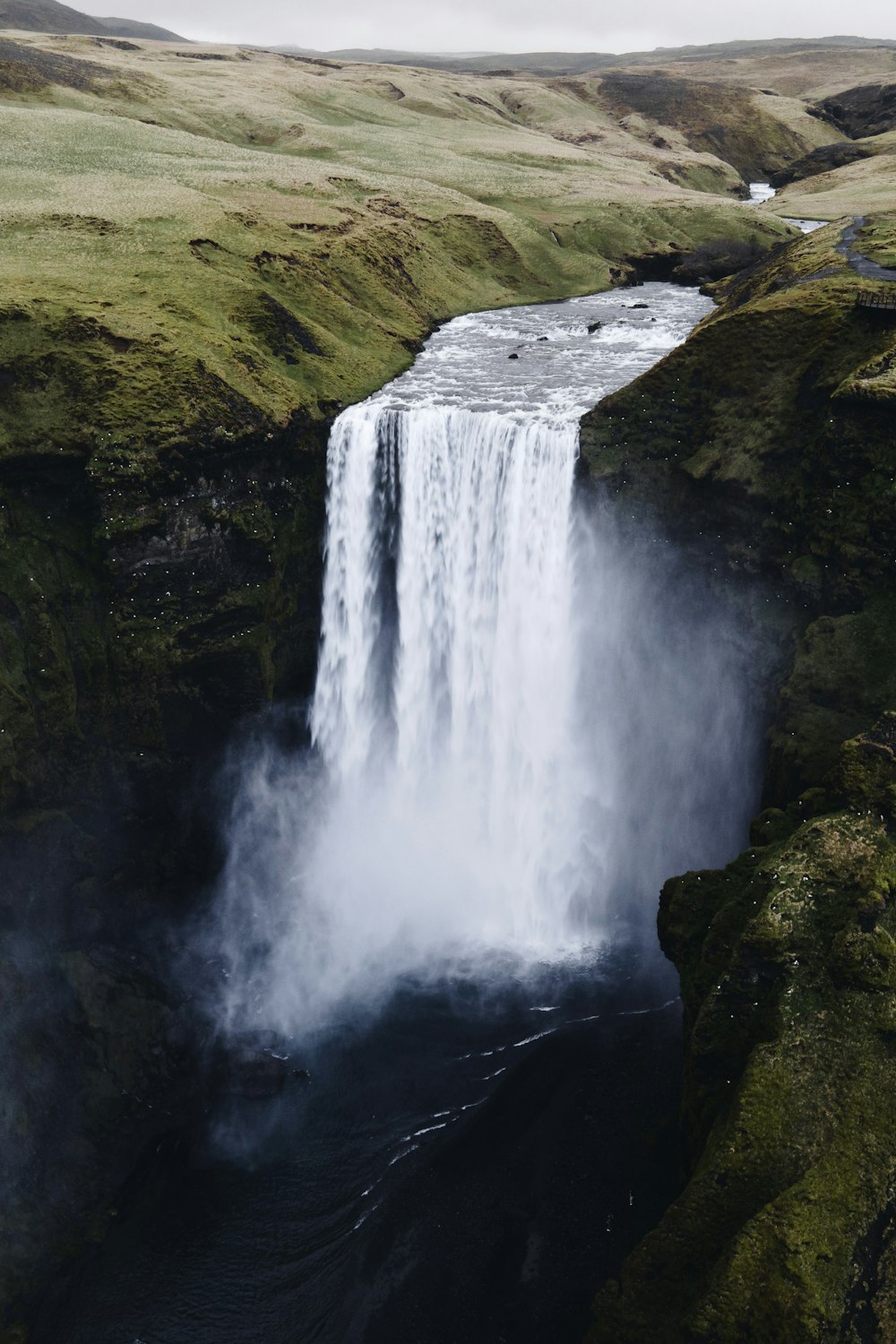 a large waterfall with water pouring out of it