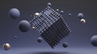 A geometric abstract scene featuring a large abstract cube made from many small dark squares, floating in space. Surrounding the cube are several spheres of varying sizes in shades of blue and metallic gold. The background is a smooth gradient of dark blue tones, enhancing a sense of depth.