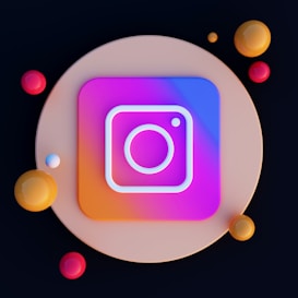 A digital artwork featuring a stylized Instagram logo centered on a circular, beige background. The logo is neon with a gradient of purple, pink, and blue. Surrounding the logo are various colored spheres in shades of red, orange, and yellow.