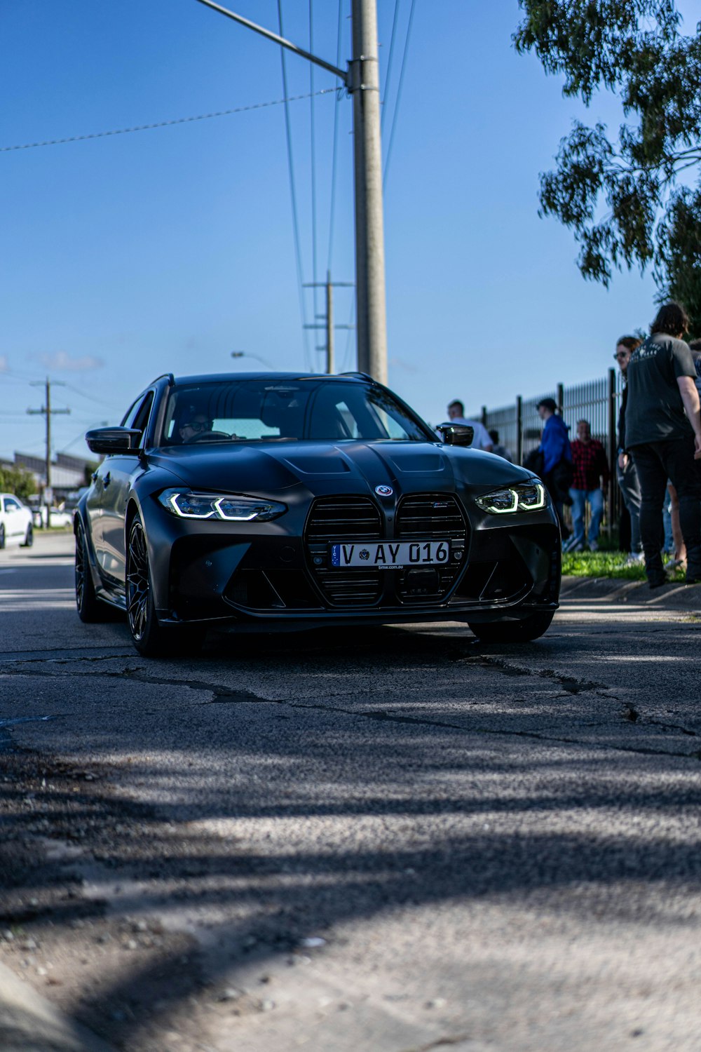 a black car parked on the side of the road