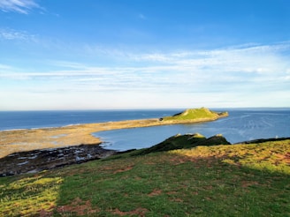 Scenic view of Salling peninsula showing coastal cliffs and lush greenery under a soft morning light.