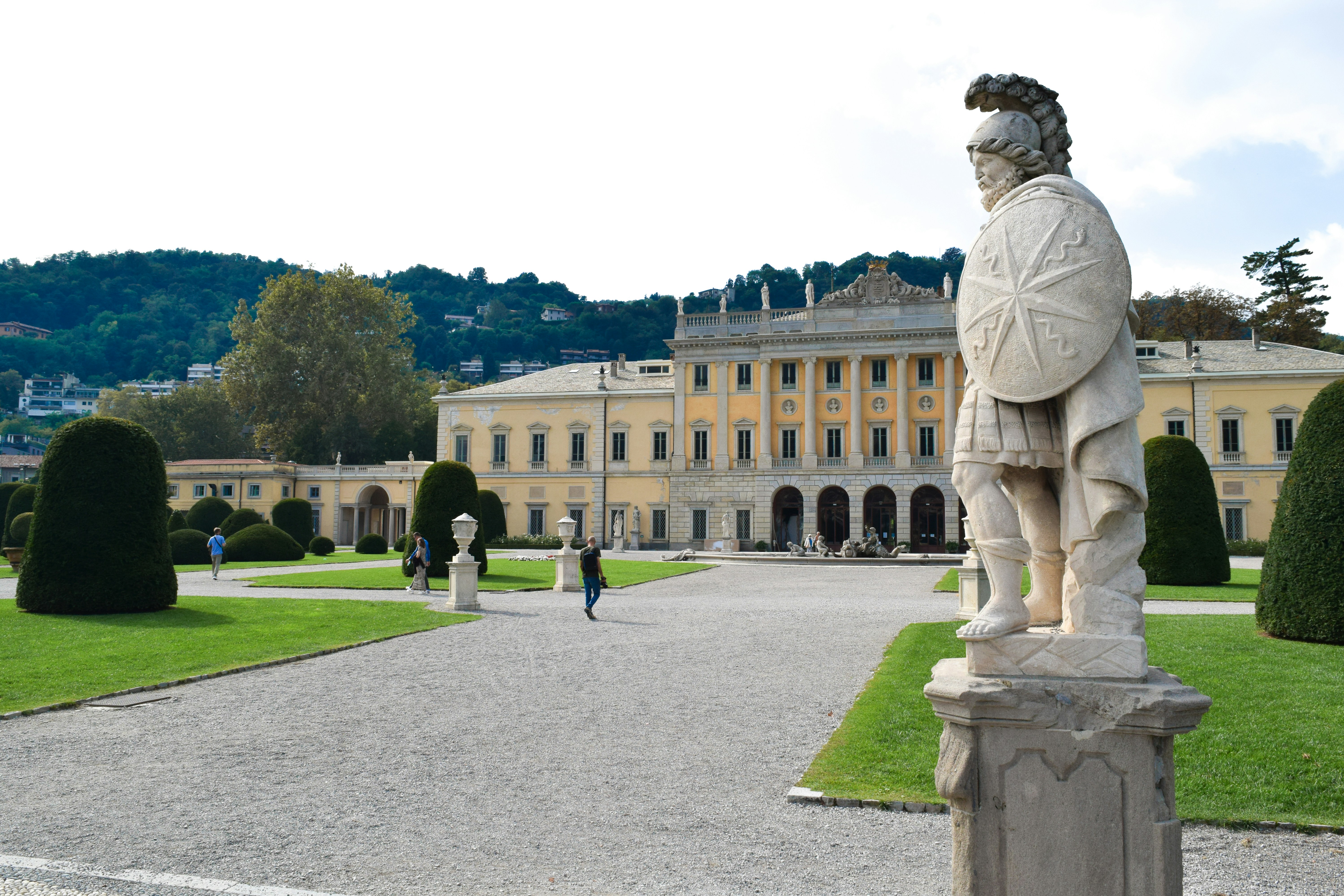 a statue of a man standing in front of a building