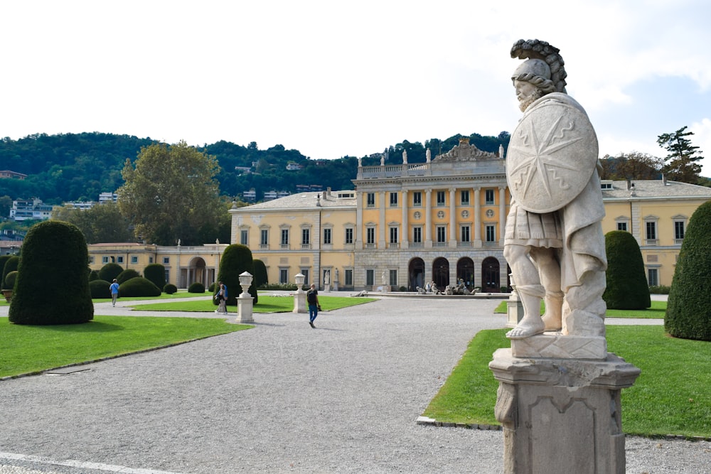 a statue of a man standing in front of a building