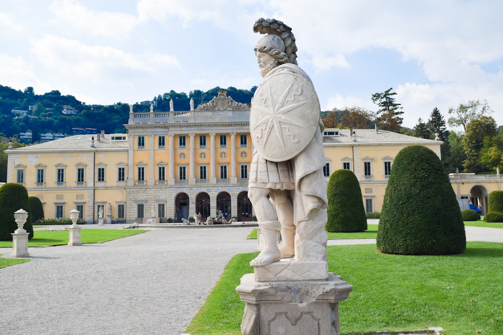 a statue of a man in front of a large building