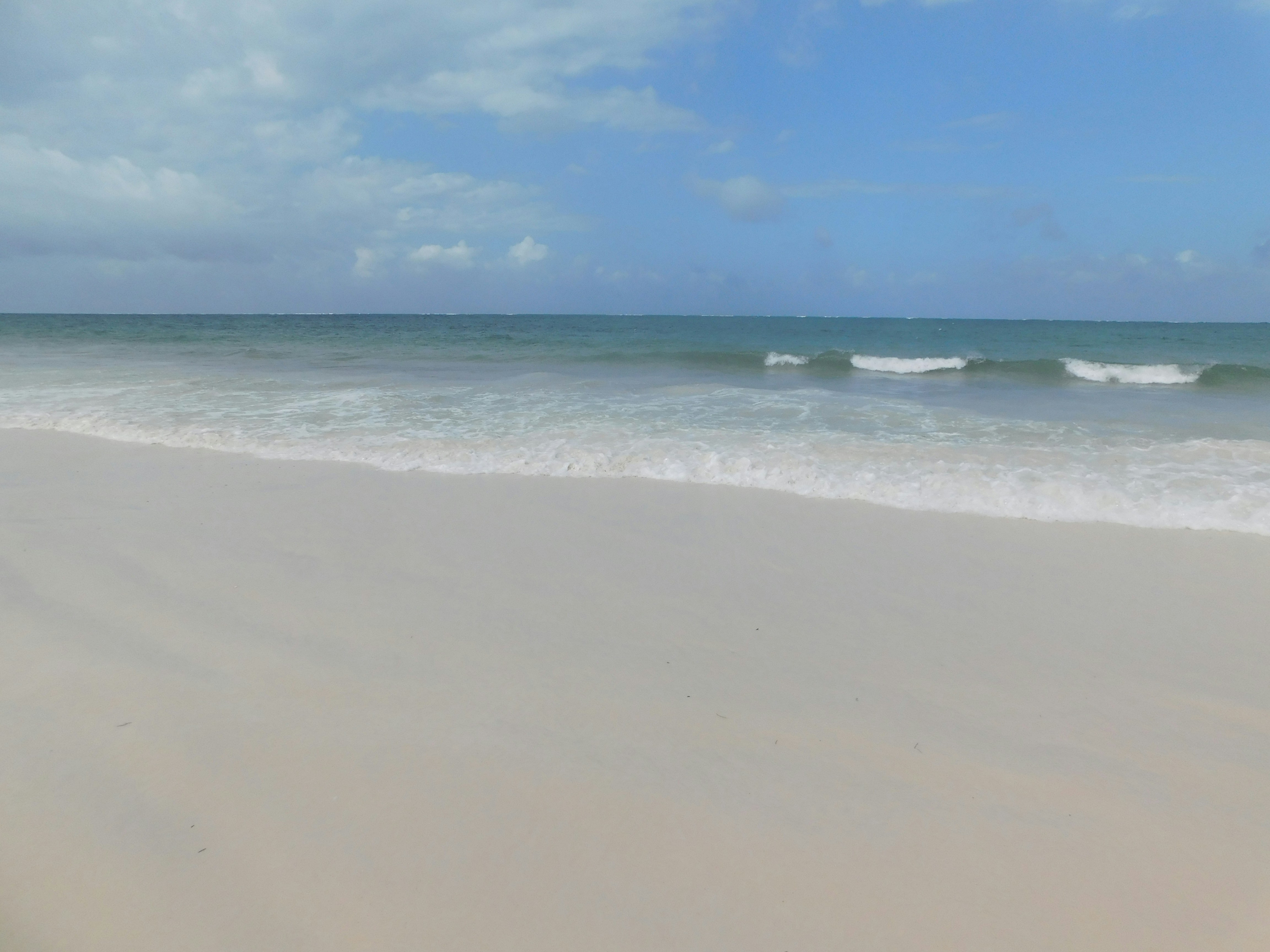 ocean photo with white sand and blue sky
