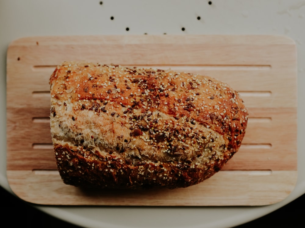 a loaf of bread sitting on top of a cutting board