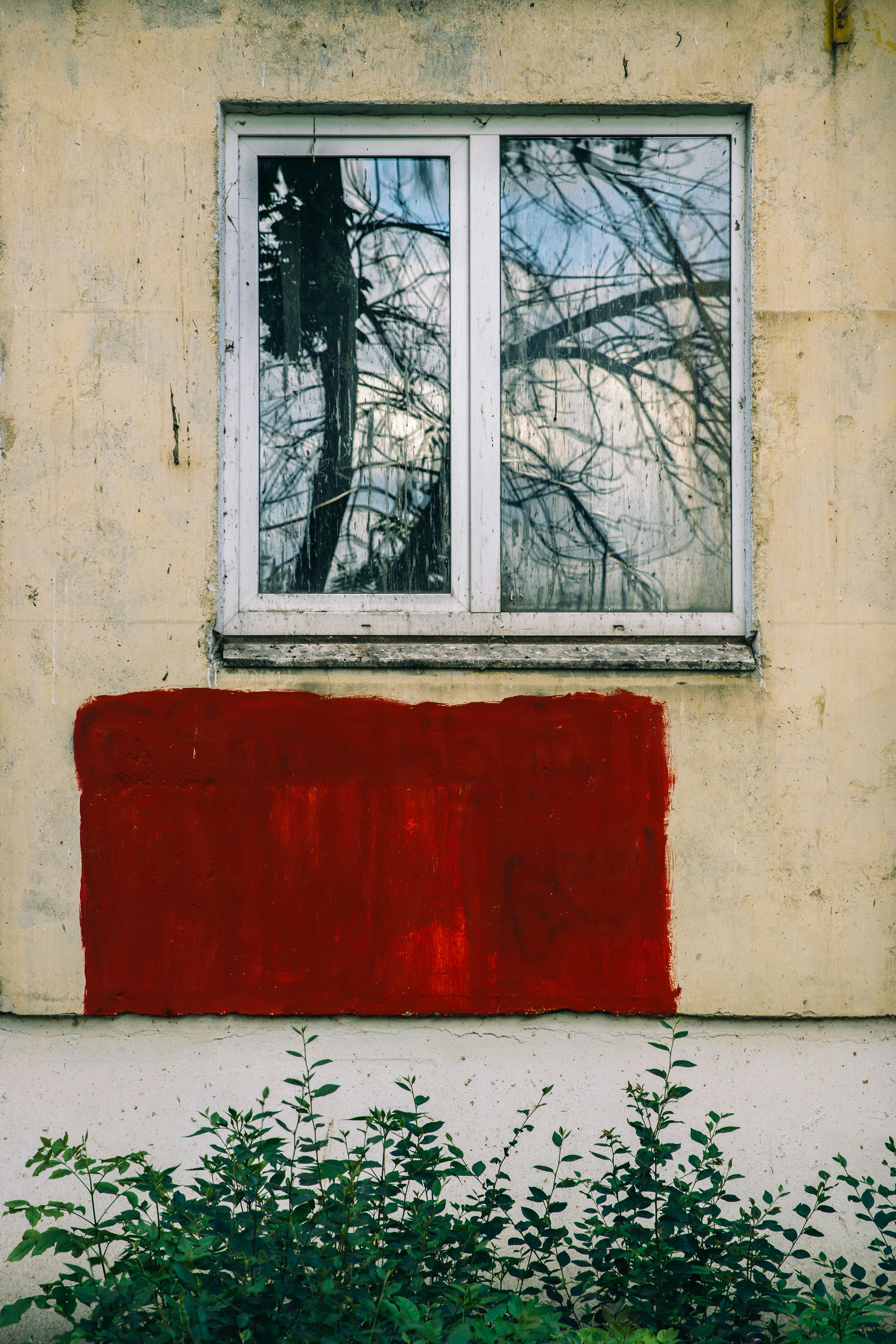 a painting of a red bench in front of a window