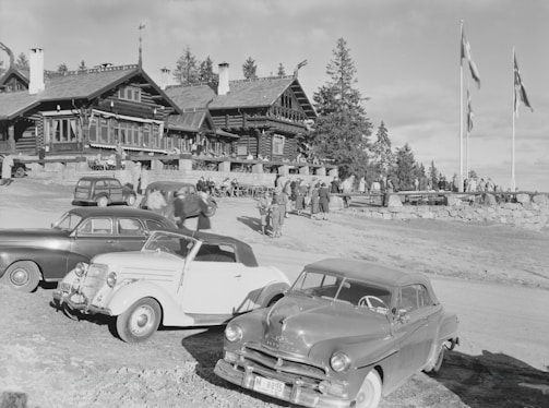 A sepia-toned photograph of the lodge's founding members gathered outside the original meeting hall, dressed in early 20th-century attire.