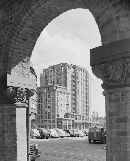 Black and white photo of downtown Columbia, SC, capturing vintage storefronts and a classic car.