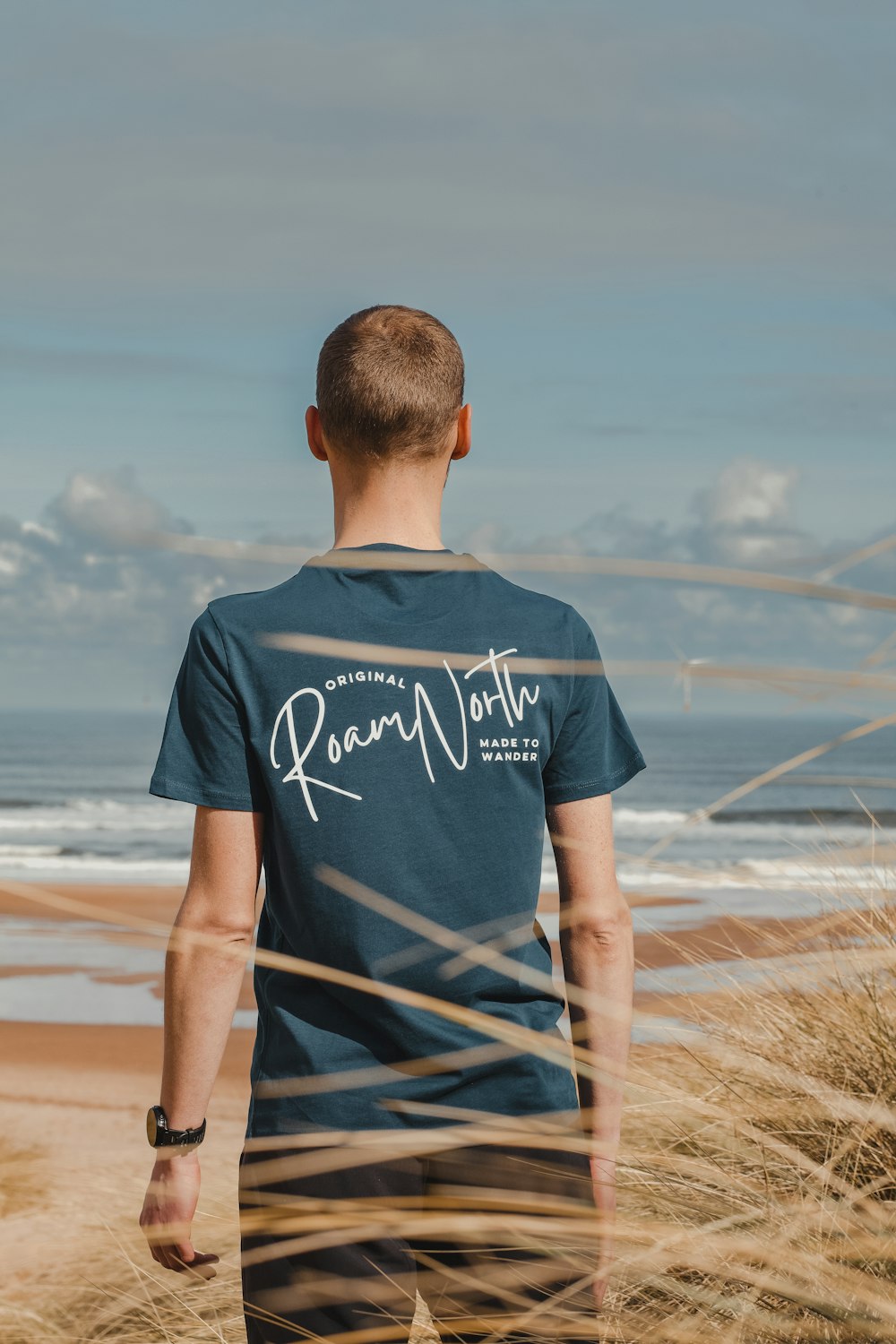 a man standing on top of a sandy beach