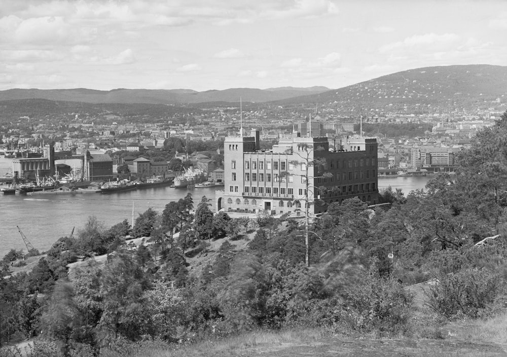 a black and white photo of a city and a river