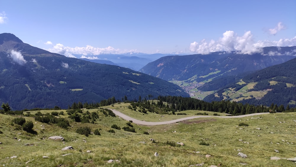 a scenic view of a road in the mountains